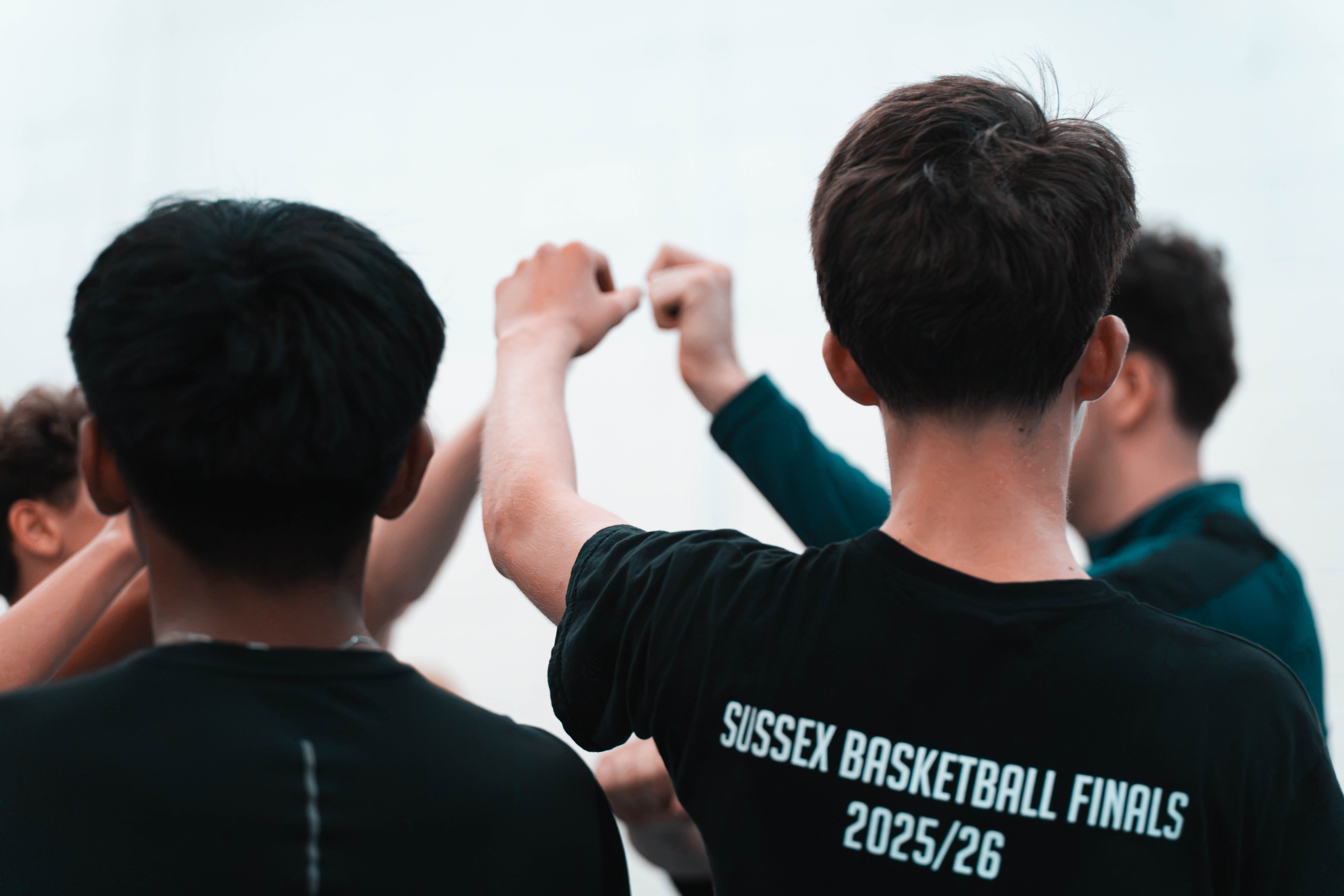Worthing D&D players putting their hands in together on court